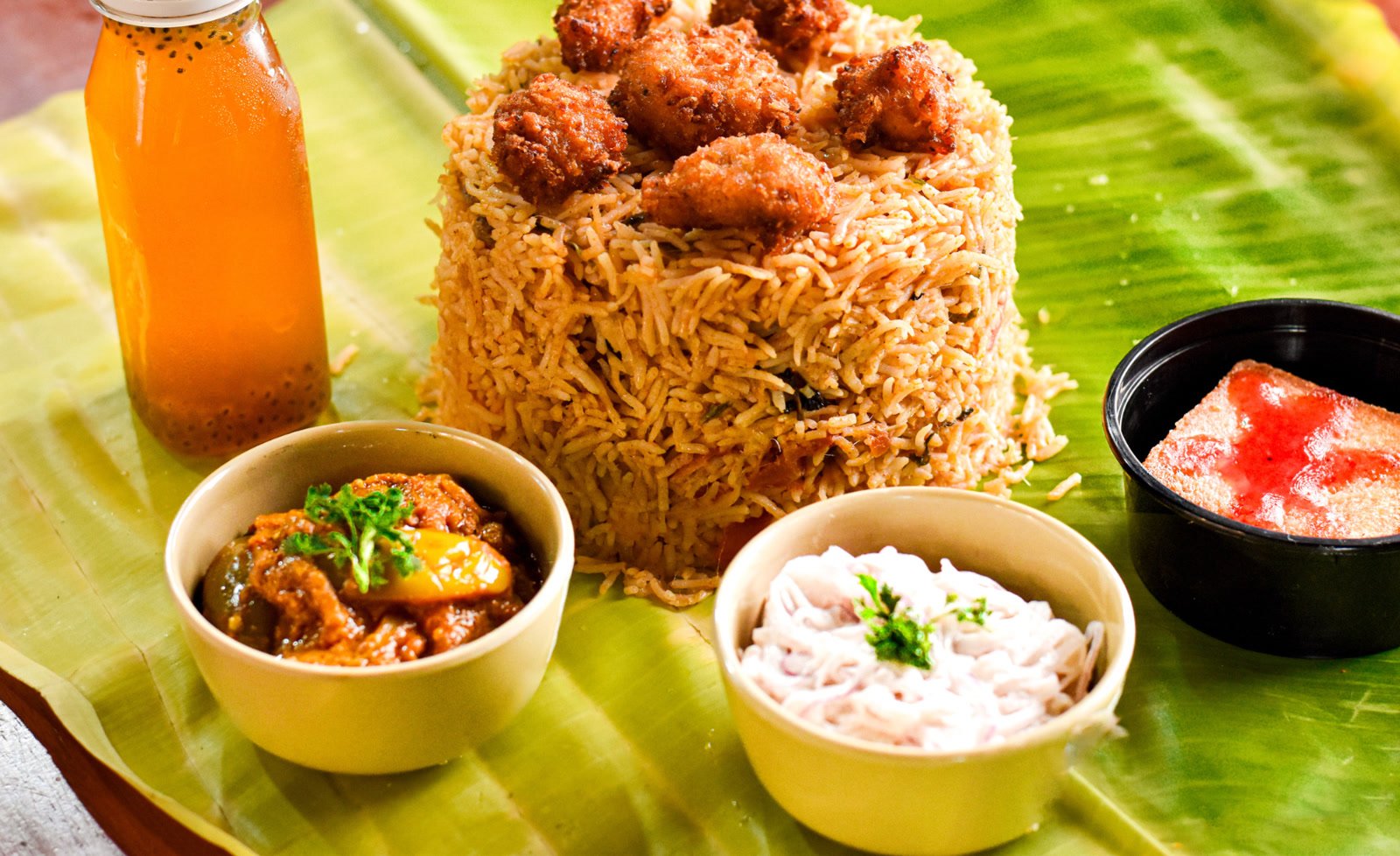 Fried chicken biriyani with raita and brinjal curry